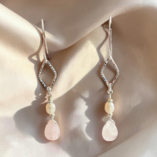 Blakeley Lane Jewelry sterling silver teardrop earrings with freshwater pearls and blush rose quartz on satin fabric