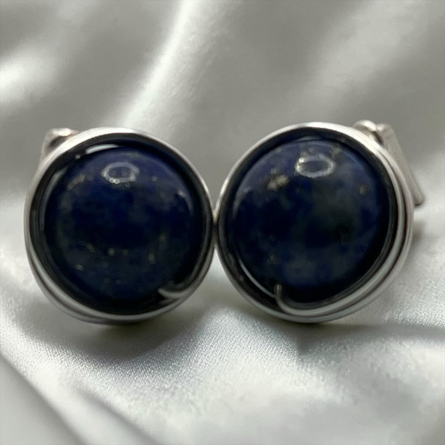 Blakeley Lane Jewelry round lapis lazuli cufflinks with deep blue stones and polished silver-tone frames.