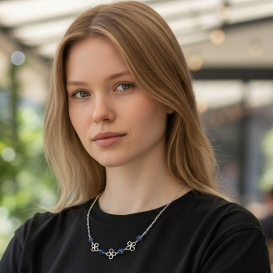 Blakeley Lane Jewelry silver chain necklace with midnight-blue beaded stones and clover motifs worn by a blonde model.