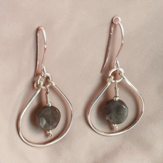 Blakeley Lane Jewelry handcrafted sterling silver teardrop earrings with faceted smoky grey gemstones on a soft cloth
