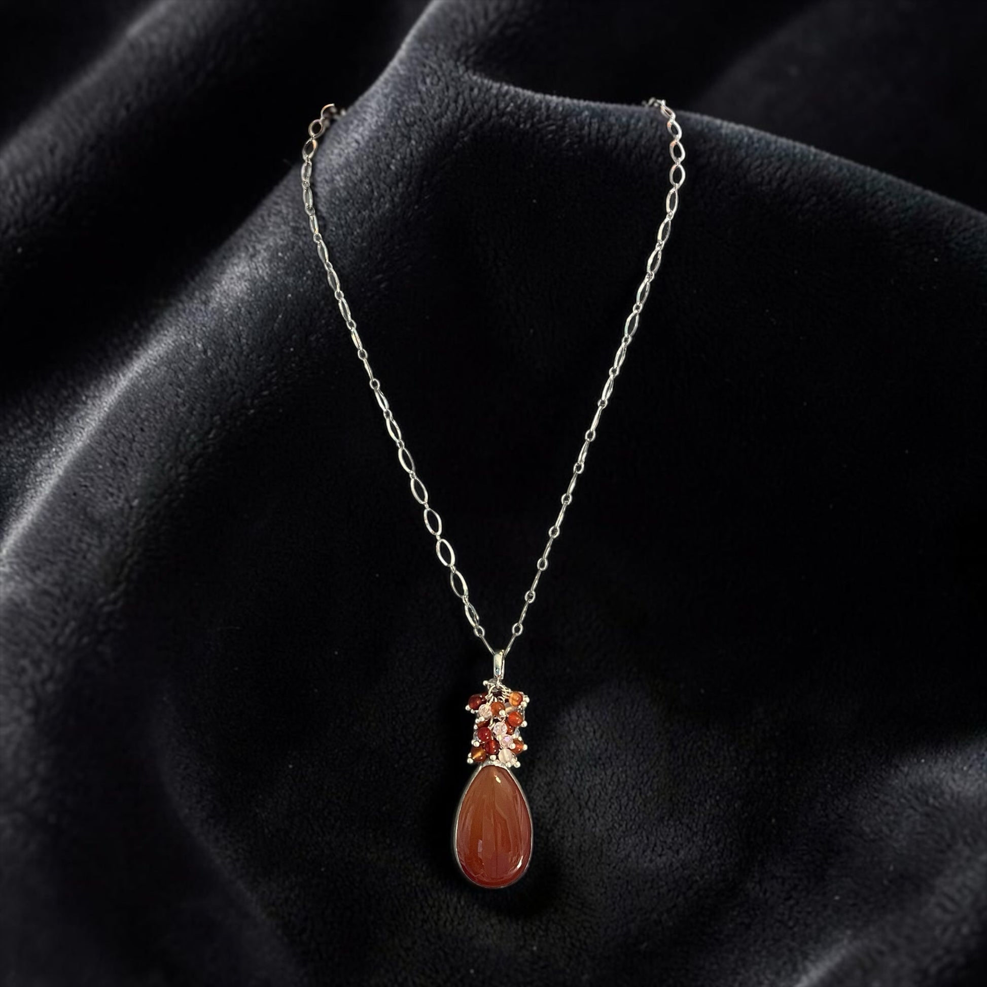 Blakeley Lane Jewelry teardrop pendant necklace with a polished amber stone and accent gems on a silver-tone chain.
