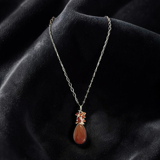 Blakeley Lane Jewelry teardrop pendant necklace with a polished amber stone and accent gems on a silver-tone chain.