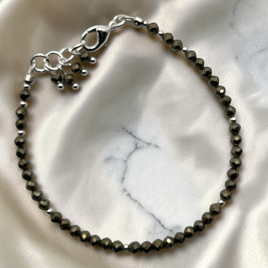Bracelet of f f faceted pyrite beads accented with silver seed beads