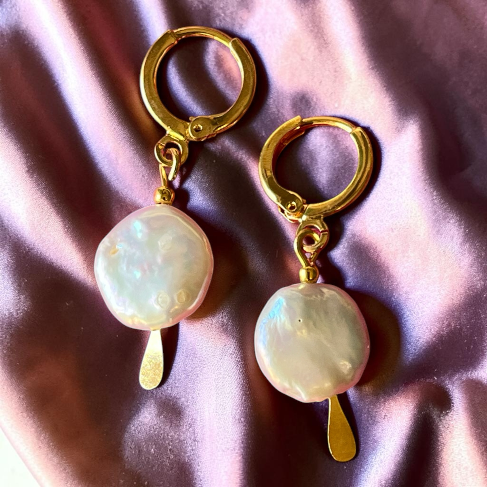 Coin pearl hung from gold huggie style ear wires