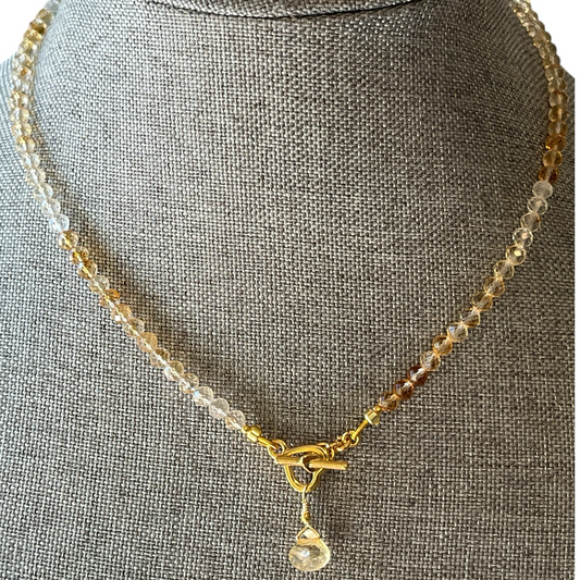 Necklace with a pendant on a gray mannequin bust