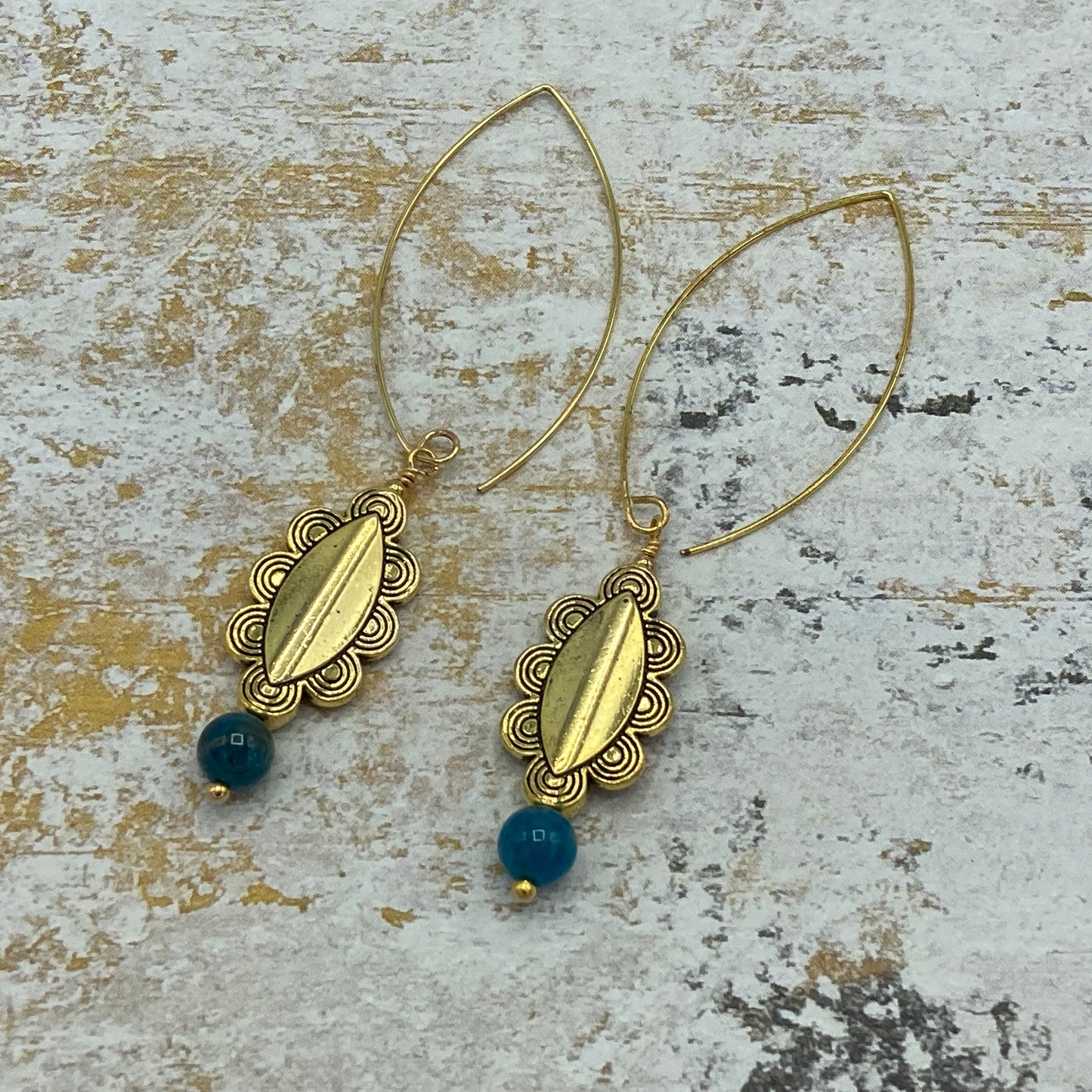 Marquise-shaped ear wires are finished with gold-colored patterned spacer beads and Apatite beads.