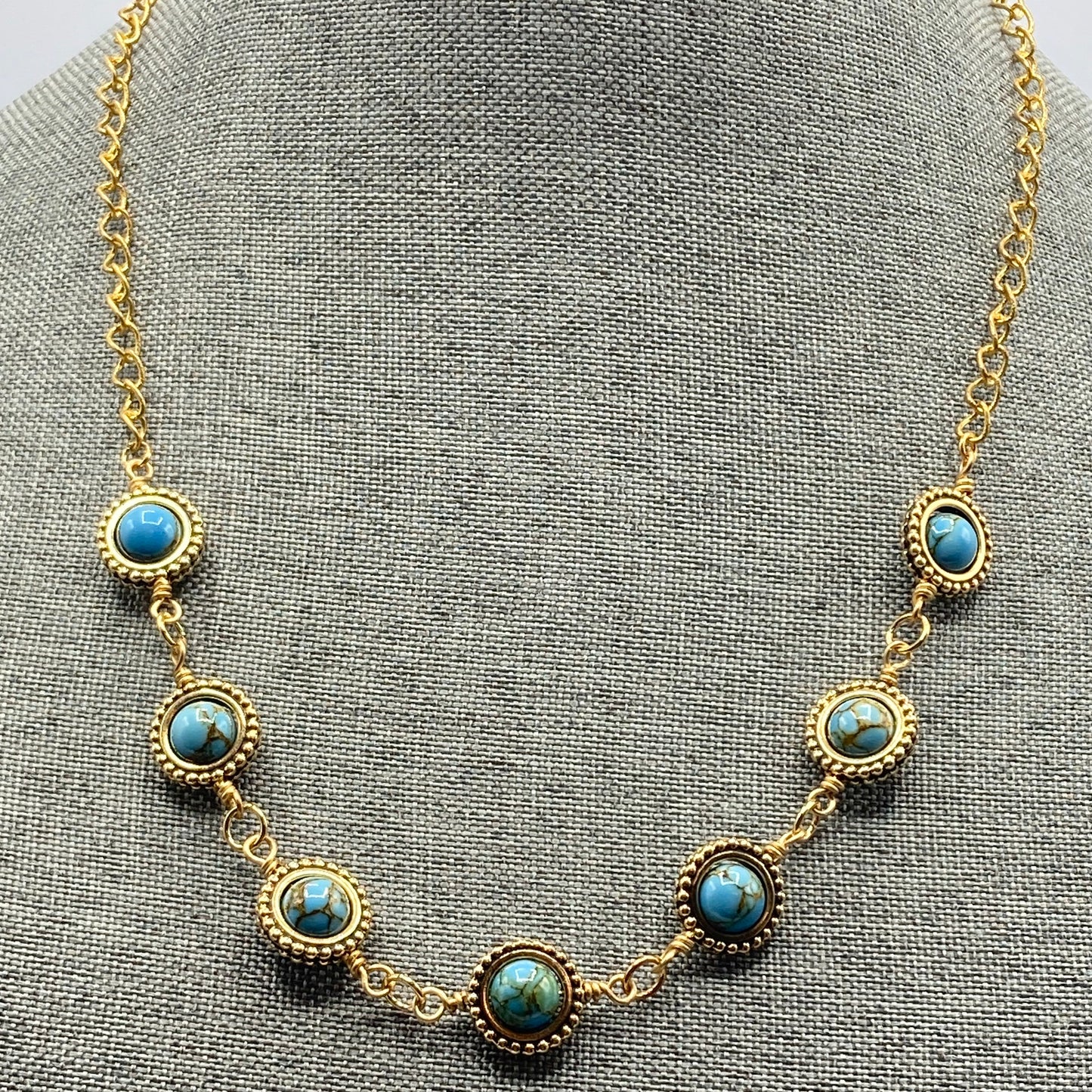 This necklace is made with 6mm Dolomite beads that are strung on a gold-tone chain. The beads are enclosed in gold-colored bead frames. The necklace measure 20 to 24 inches.