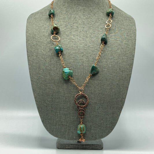 This necklace is made with Turquoise nuggets, and hammered rings, and connected with a handmade copper chain. It measures approximately 30 inches.