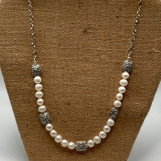 This 24-inch necklace is made with freshwater pearls and ornate rectangular metal beads.  It includes a 2-inch extender.  Pearls are timeless and you can dress up or down with this necklace.