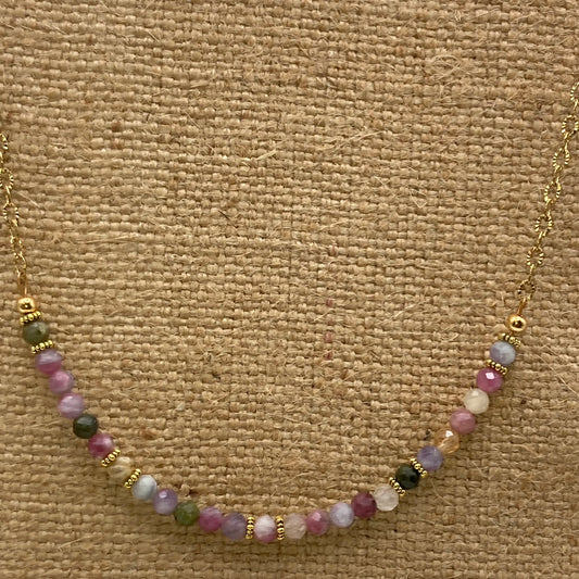 This 18-inch necklace is made with 4mm multicolor faceted Tourmaline beads, and gold daisy spacer beads strung on a gold-tone chain.