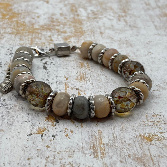 This bracelet is made with Agate beads and silver spacer beads. 3 large smokey quartz-colored beads provide additional color. The bracelet fits up to an 8.25-inch wrist and includes a magnetic clasp. Once you determine your size, the bracelet is easily taken on and off using the magnetic clasp.