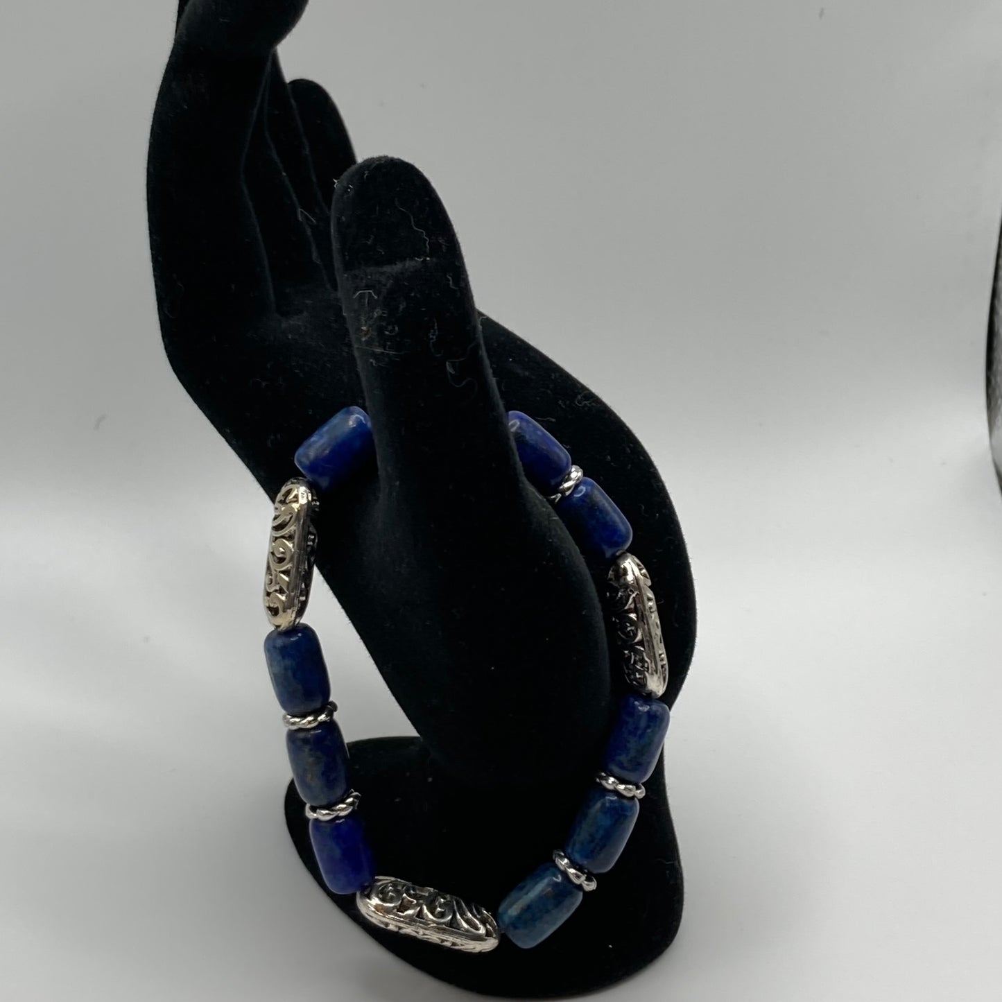 This bracelet is made with barrel-shaped Lapis beads, "vine" metal beads, and rope spacer beads