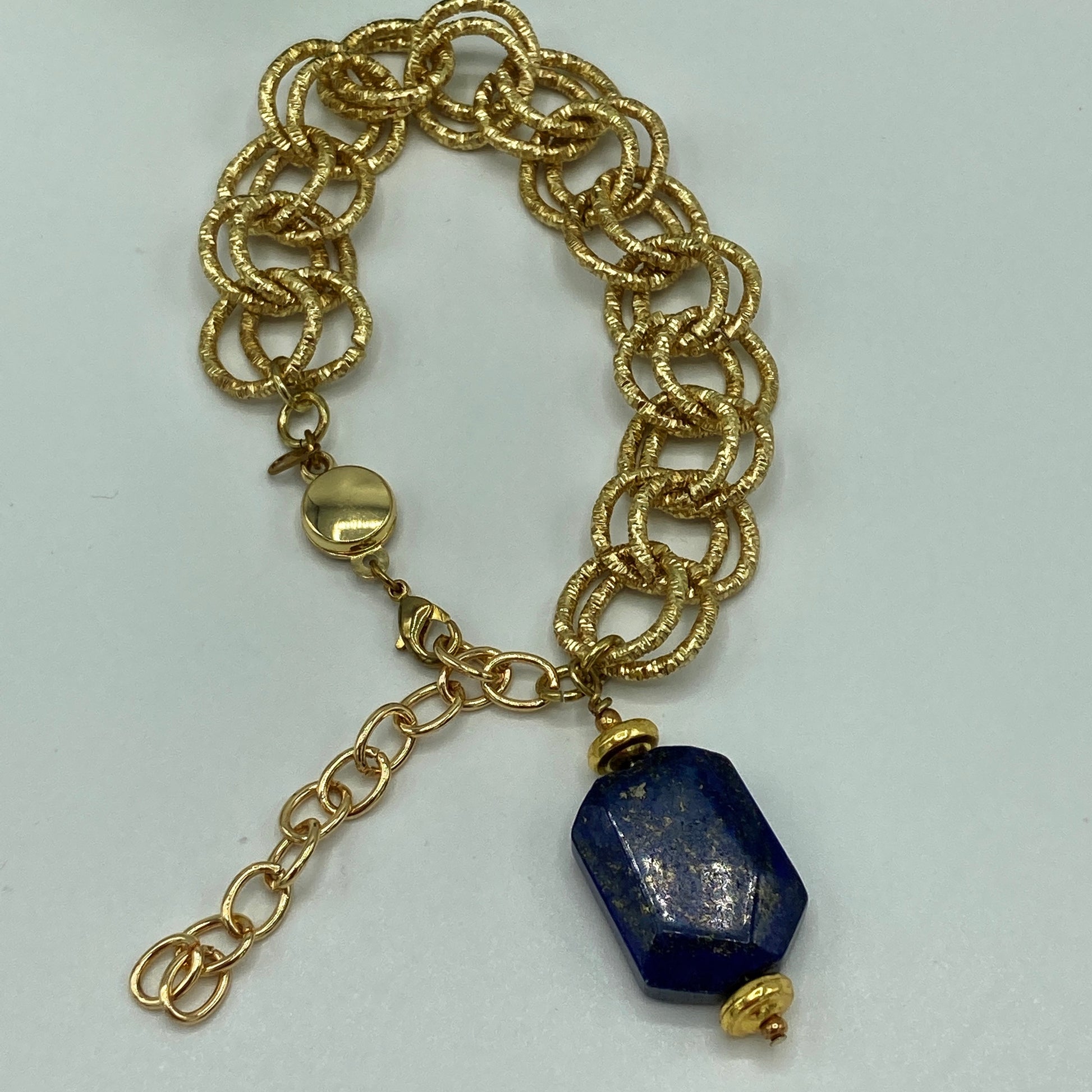 Large gold link chain with single Lapis cube focal. The bracelet includes a magnetic clasp which makes putting the bracelet on and taking it off easy.