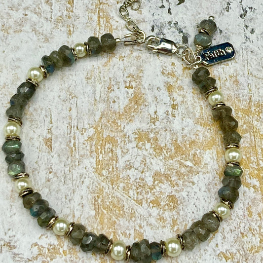 This piece is made with Labradorite rondelles, tiny pearls, and love-knot-spacer beads, creating a dainty and delicate bracelet. The extender clasp allows for multiple wrist sizes.