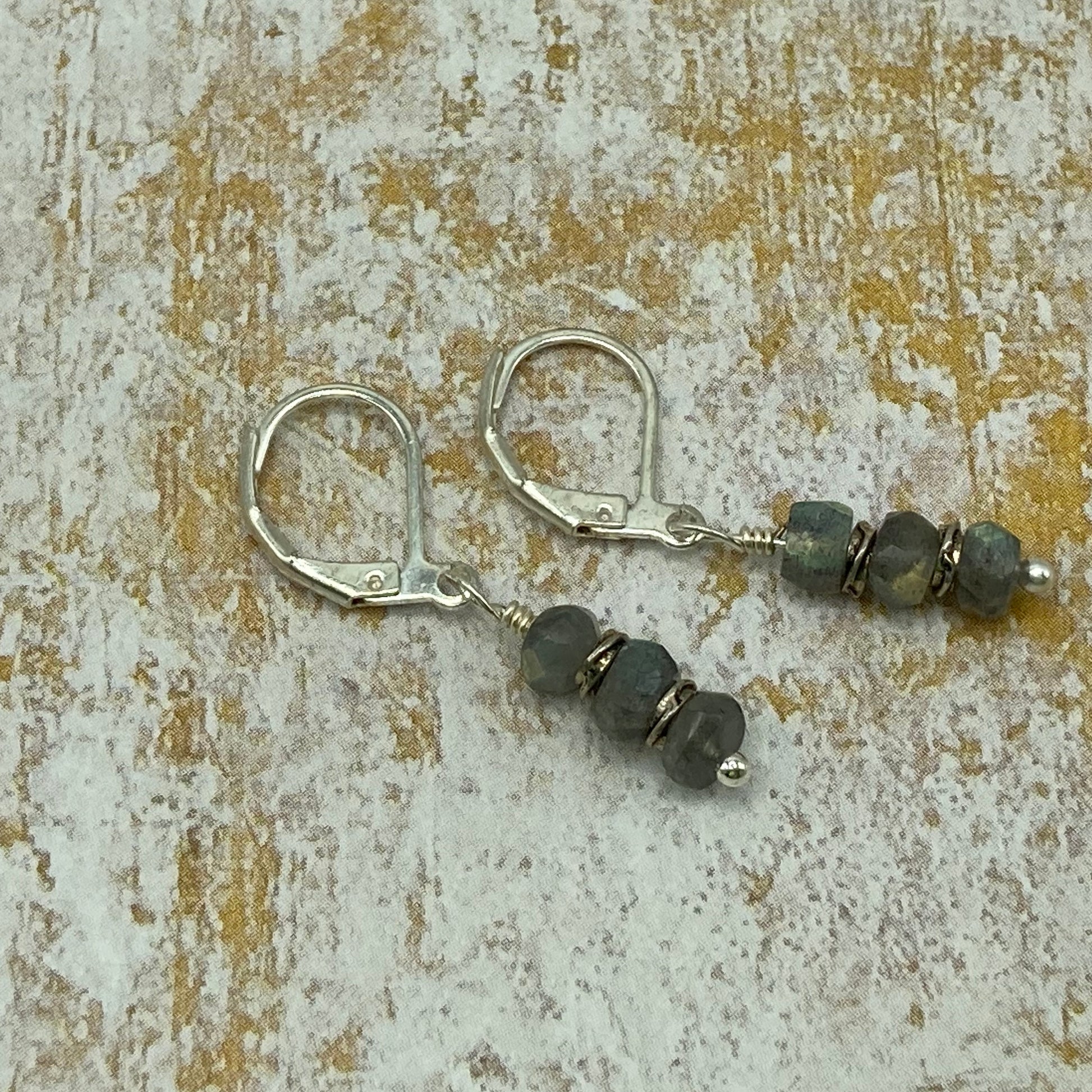 Earrings are made with Labradorite rondelles and love knot spacer beads. Simple but elegant.