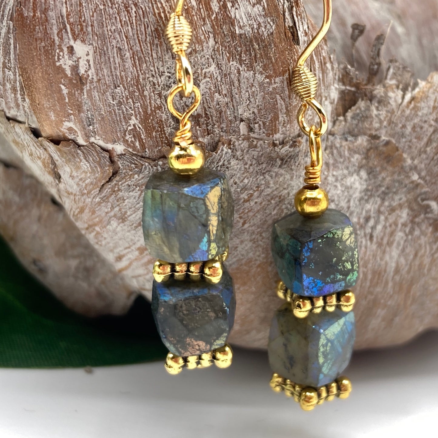 Earrings are made with cube-shaped Labradorite and accented with gold spacer beads. The stones are faceted which adds to the beauty and brilliance of the stone. A coordinating necklace is sold separately.