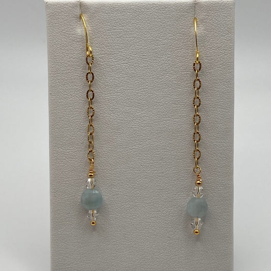 Checkerboard coin-shaped Aquamarine beads hang delicately from delicate gold chains.  The earring measure approximately 2 inches long