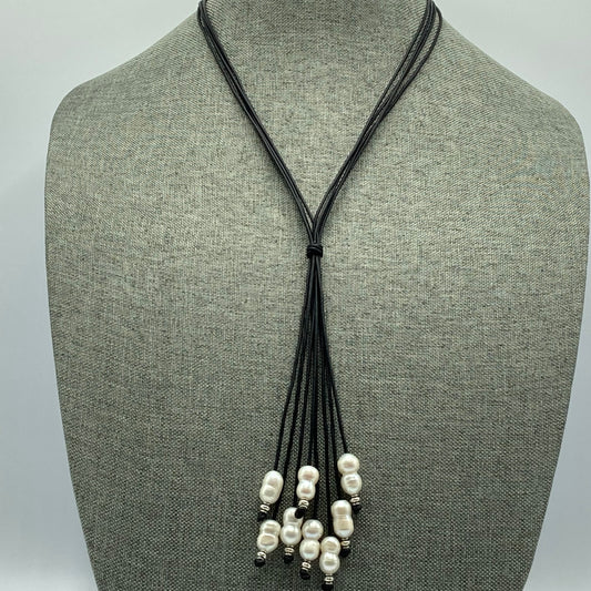 The necklace features 8 large-hole pearls strung on 1mm black leather.