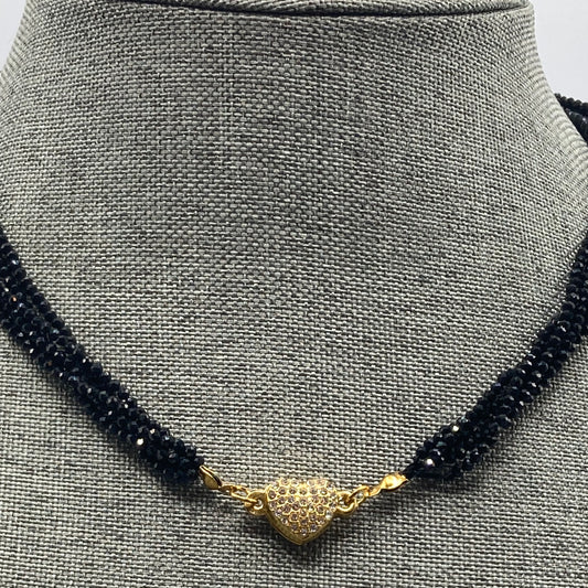 The necklace is made with 2mm Black Spinel beads and is finished with a magnetic gold tone heart clasp.