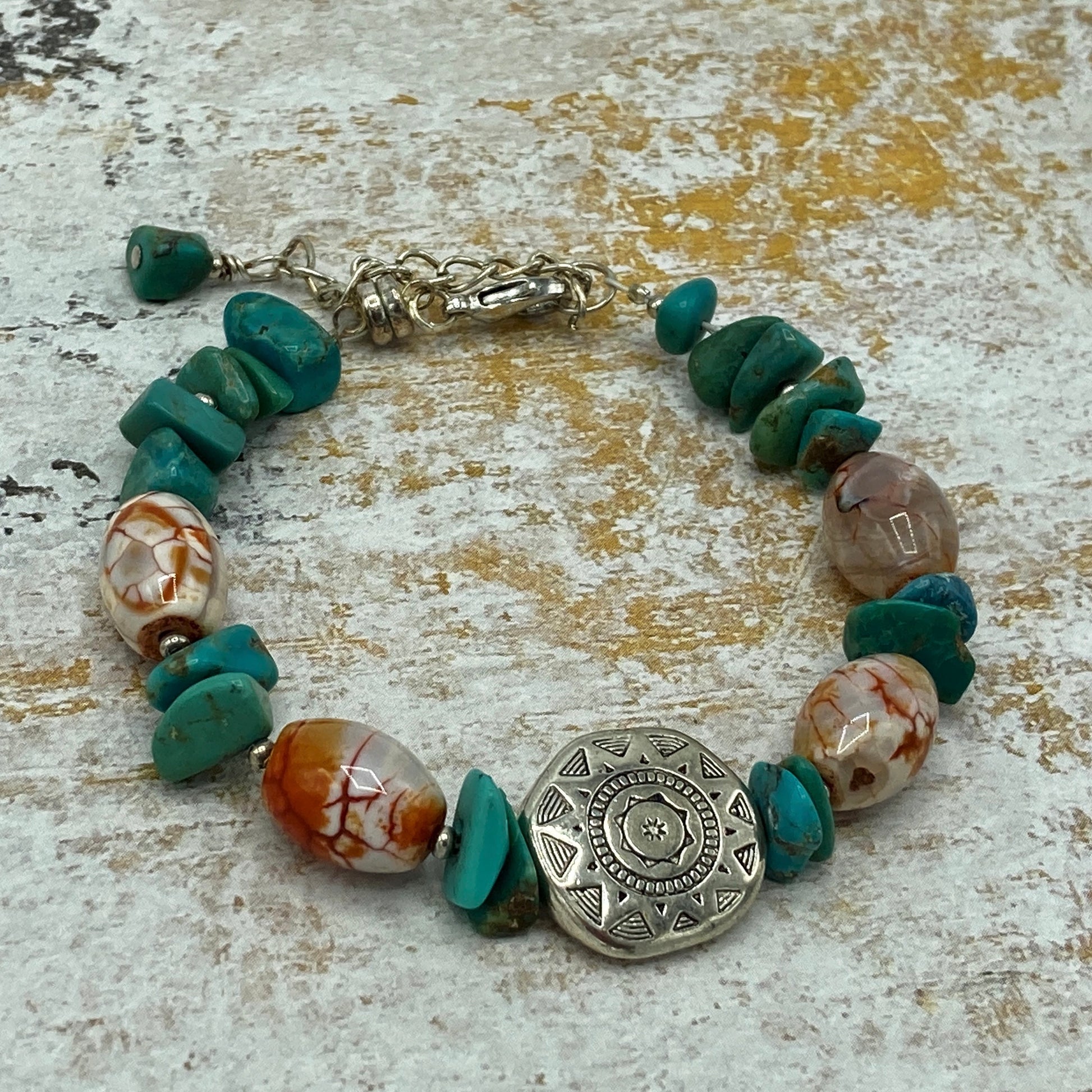 Fire Terra Agate and Turquoise chip bracelet with silver focal.  The bracelet includes an expander to allow for multiple wrist sizes and a magnetic clasp which makes putting on and taking the bracelet off easily