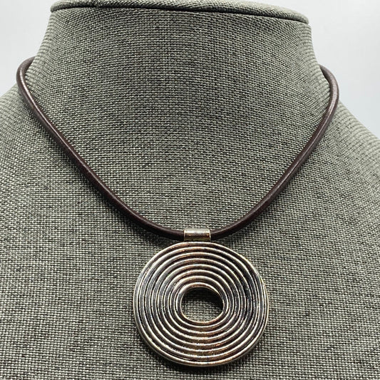 The 15.5" necklace is made with 2mm brown leather and a silver swirl pendant.