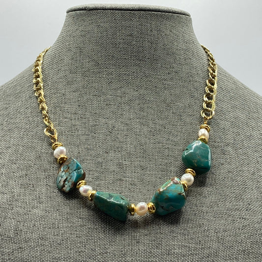 This necklace is 20" long and includes a 2" expander. It is made with free-form Turquoise nuggets and pearl beads. It is accented with gold spacer beads.